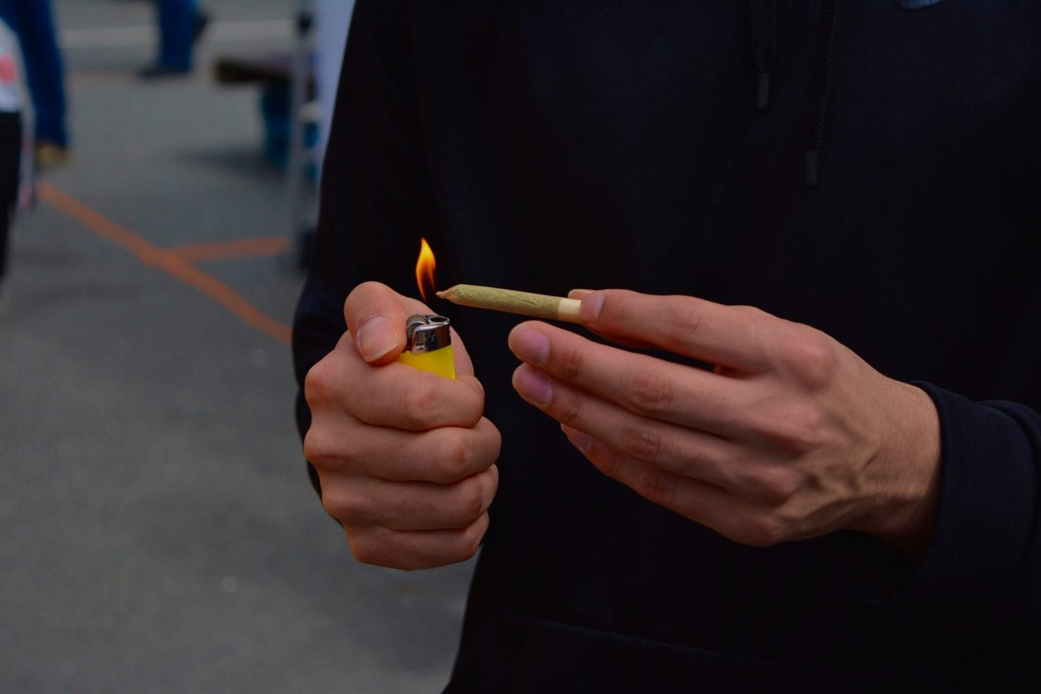 person lighting a joint at 4/20 rally. Sunset Beach Park, Vancouver, Canada