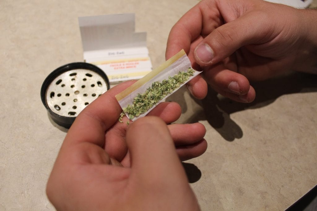 Rolling paper with cannabis inside of it. The hardest step when learning how to roll a joint is this one.