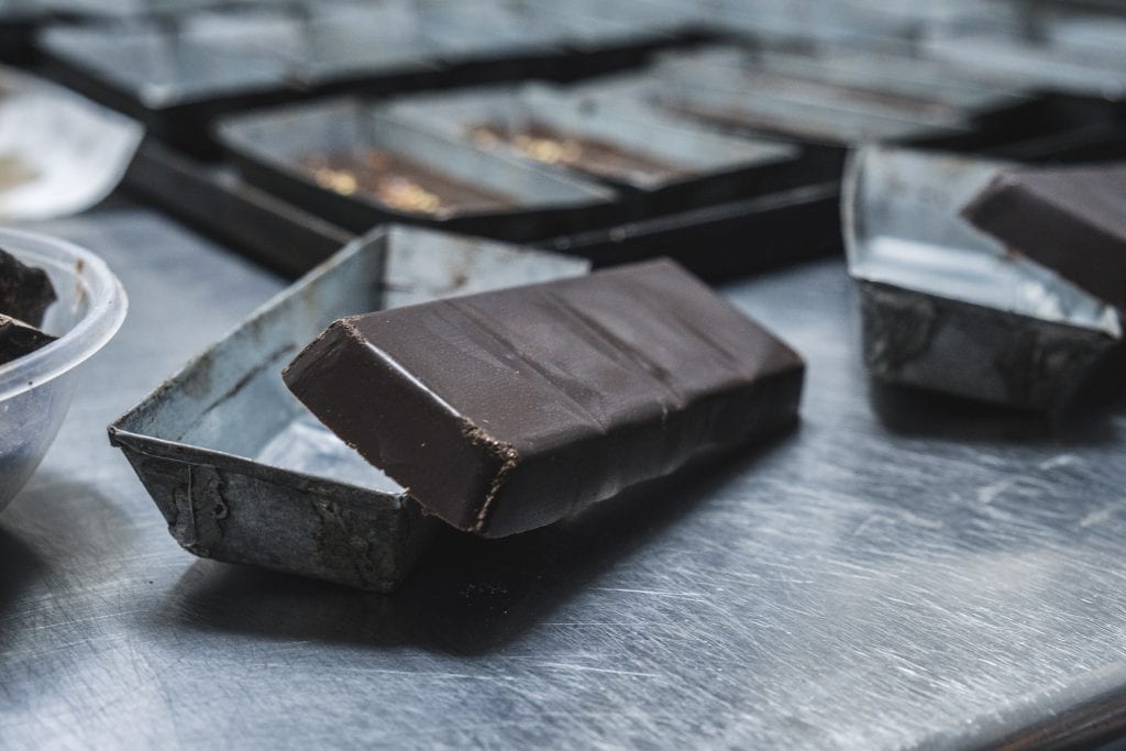 Chocolate bar leaning against bar mould