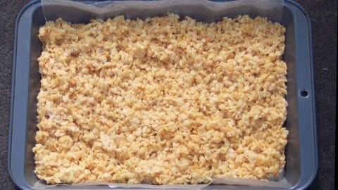 a pan of cannabis-infused rice krispy edibles. the brown rice crispies are in a square shape.