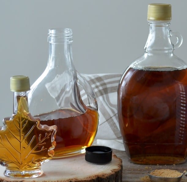 weed maple syrup cannabis edible. The maple syrup shaped bottle holds the golden color syrup inside.