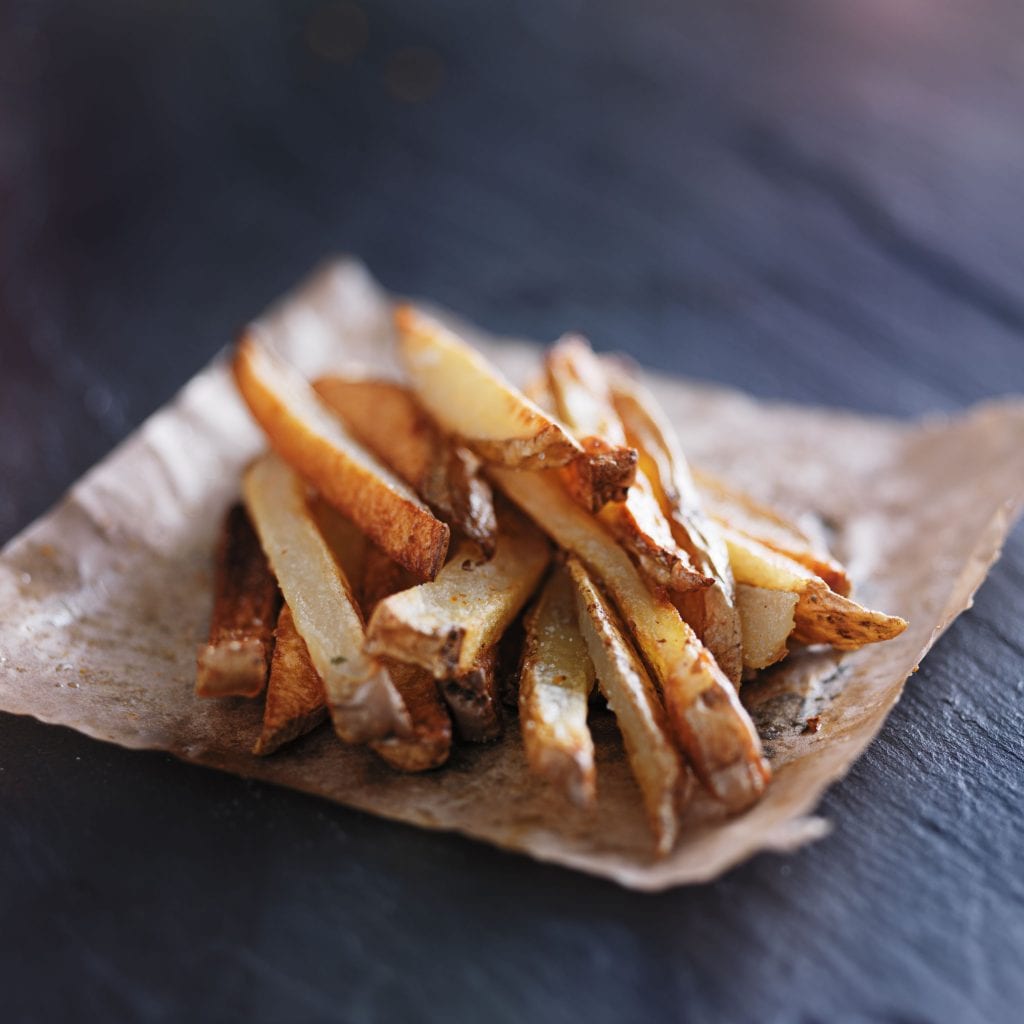 home made weed french fries on a napkin on a black table