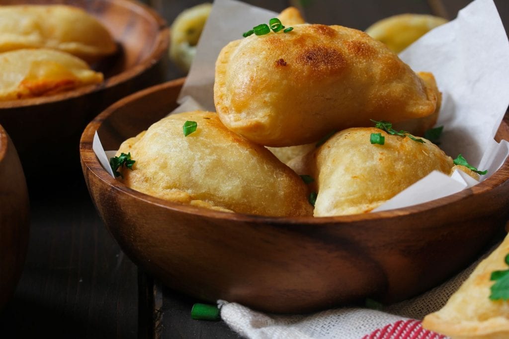 I made weed potato and cheese pierogies In the wooden bowl with pierogies in the background