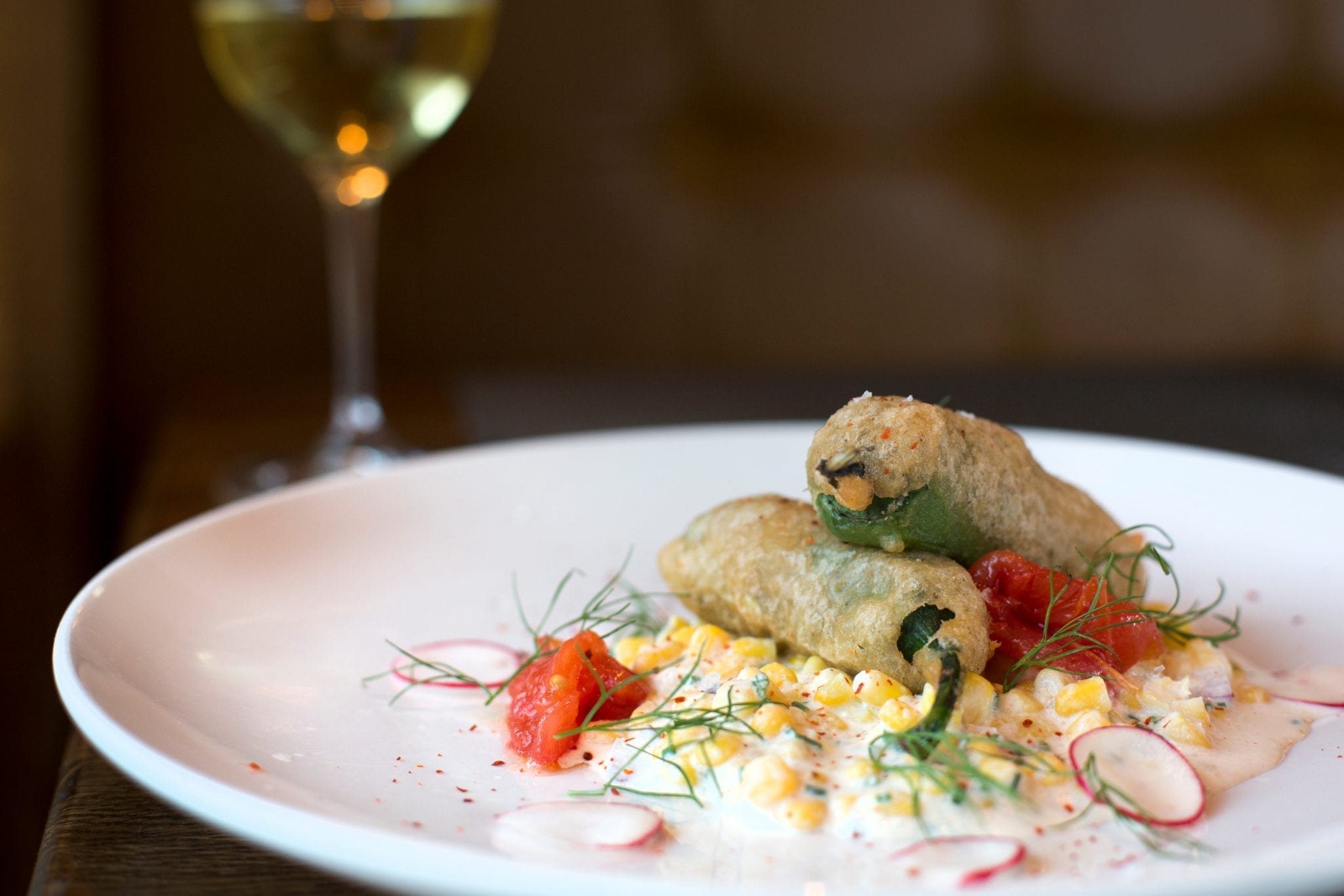 cannabis Jalapeño Poppers with fresh jalapeno, lump crab meat, beer batter and cool creamed corn salad