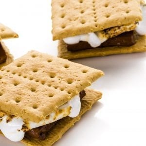 3 Cannabis infused smores ona white table. Marshmallows melting out the side of the smore