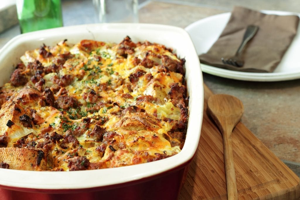 A breakfast weed casserole made from French baguette bread, sage breakfast sausage, onions and cheddar cheese