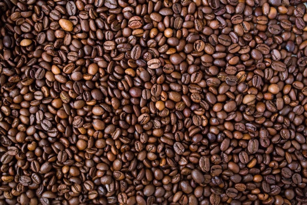 Macro image of thousands of coffee beans piled on top of each other for the weed coffee infusion.