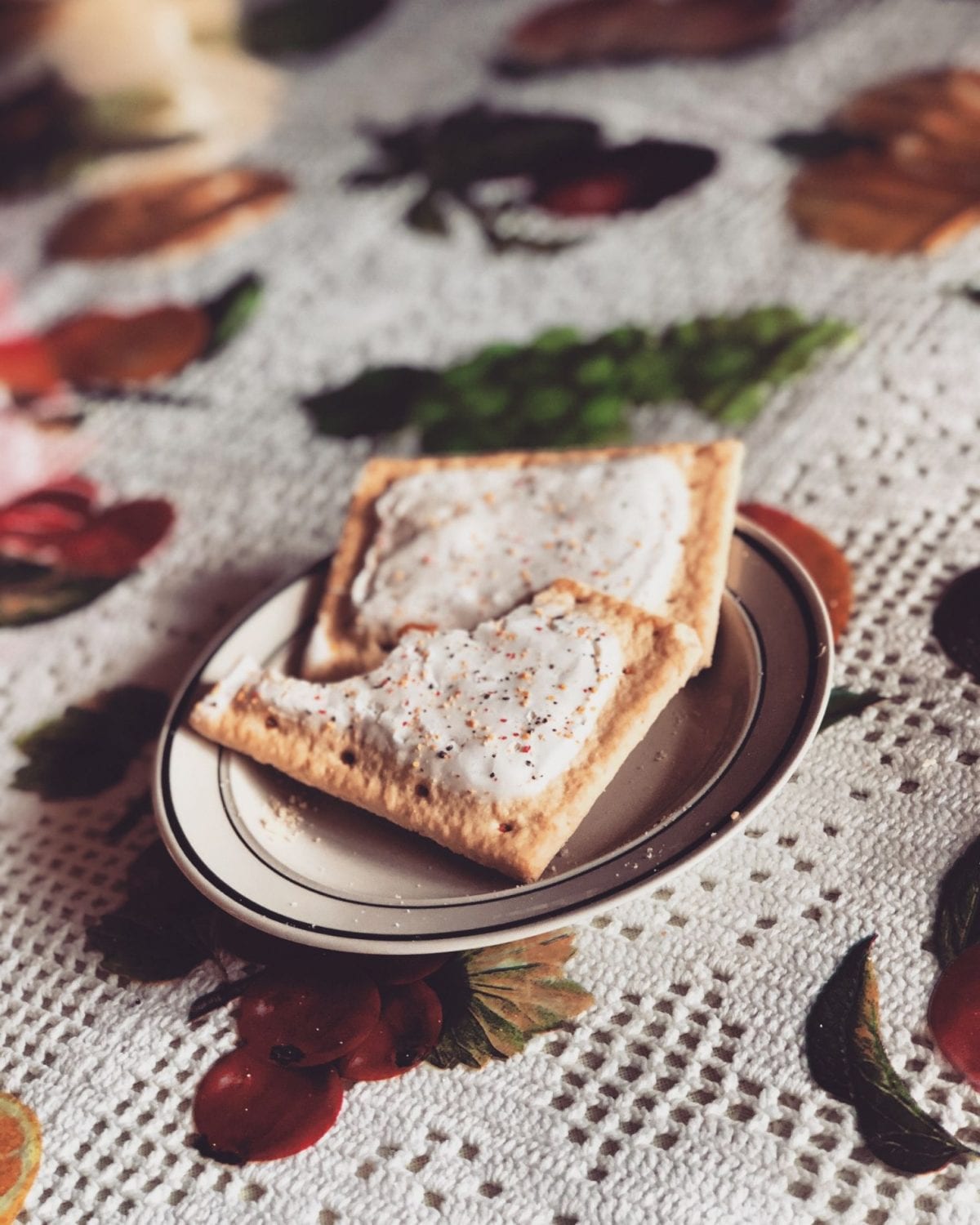 Two cannabis infused pop tarts on a plate which is on a tablecloth with berries