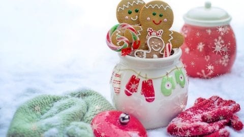 Cannabis infused gingerbread men in a jar with snow in the background