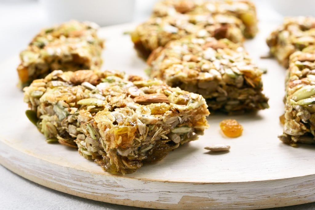 Close up of a weed granola bar on wooden board. Healthy meal for breakfast.